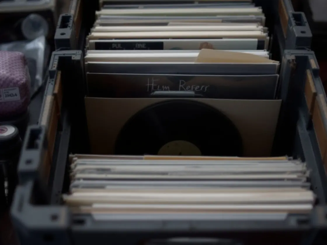 A crate of vinyl records in a record shop seen from above