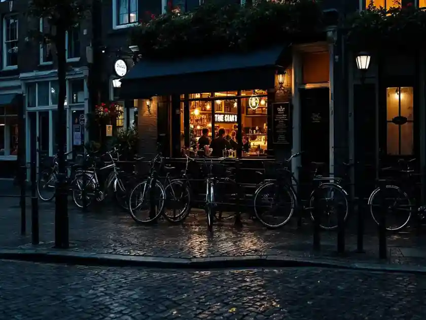 A quiet city street at dusk with bicycles parked outside a bar